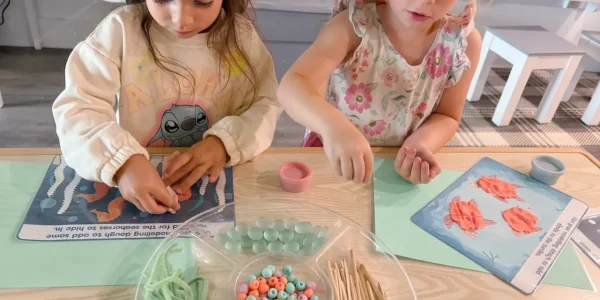 Preschool inside full-day care: how one room and one drop-off works, and why the group stays at sixteen